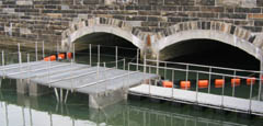 A bridge with a floating structure in front of it
