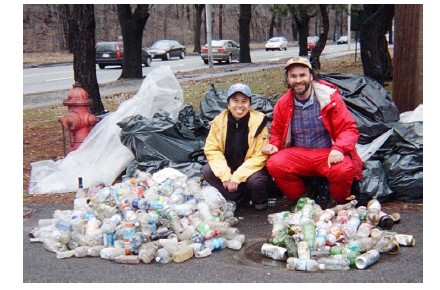 Anna Eleria and Russ Cohen posing with their piles of containers